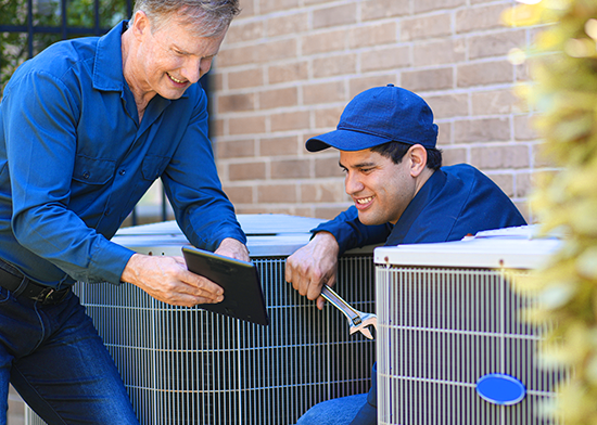 Technicians repairing air conditioning units